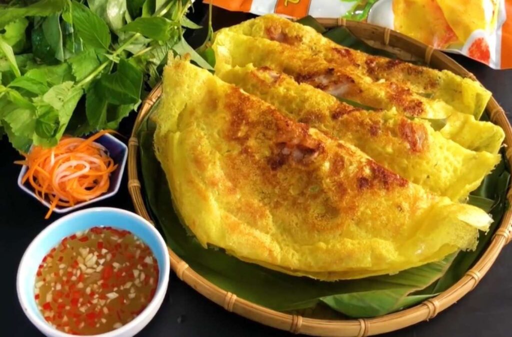 Tra Que’s Banh Xeo features a crispy crust, shrimp, pork, and fresh herbs.
